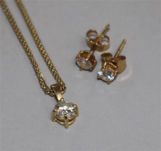 A gold and solitaire diamond set pendant on an 18ct gold chain and a pair of 18ct gold and solitaire diamond ear studs.